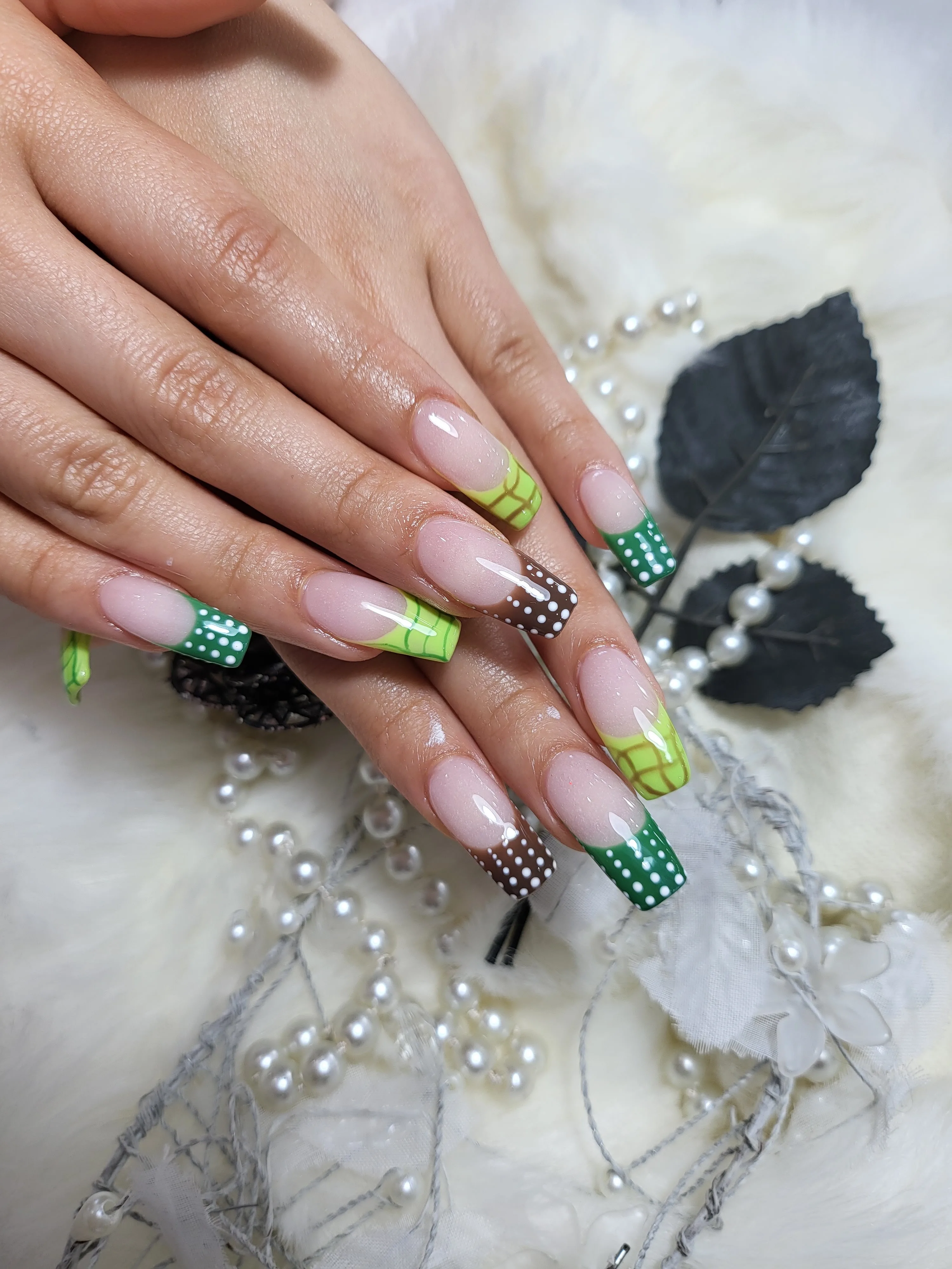 Green and lime polka-dot french-tip long nails with pearls