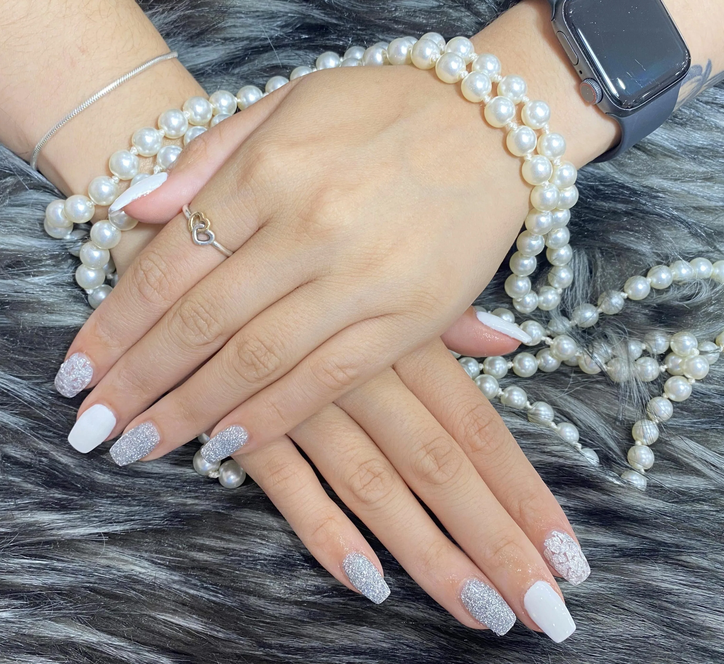White and silver-glitter square nails draped with pearls