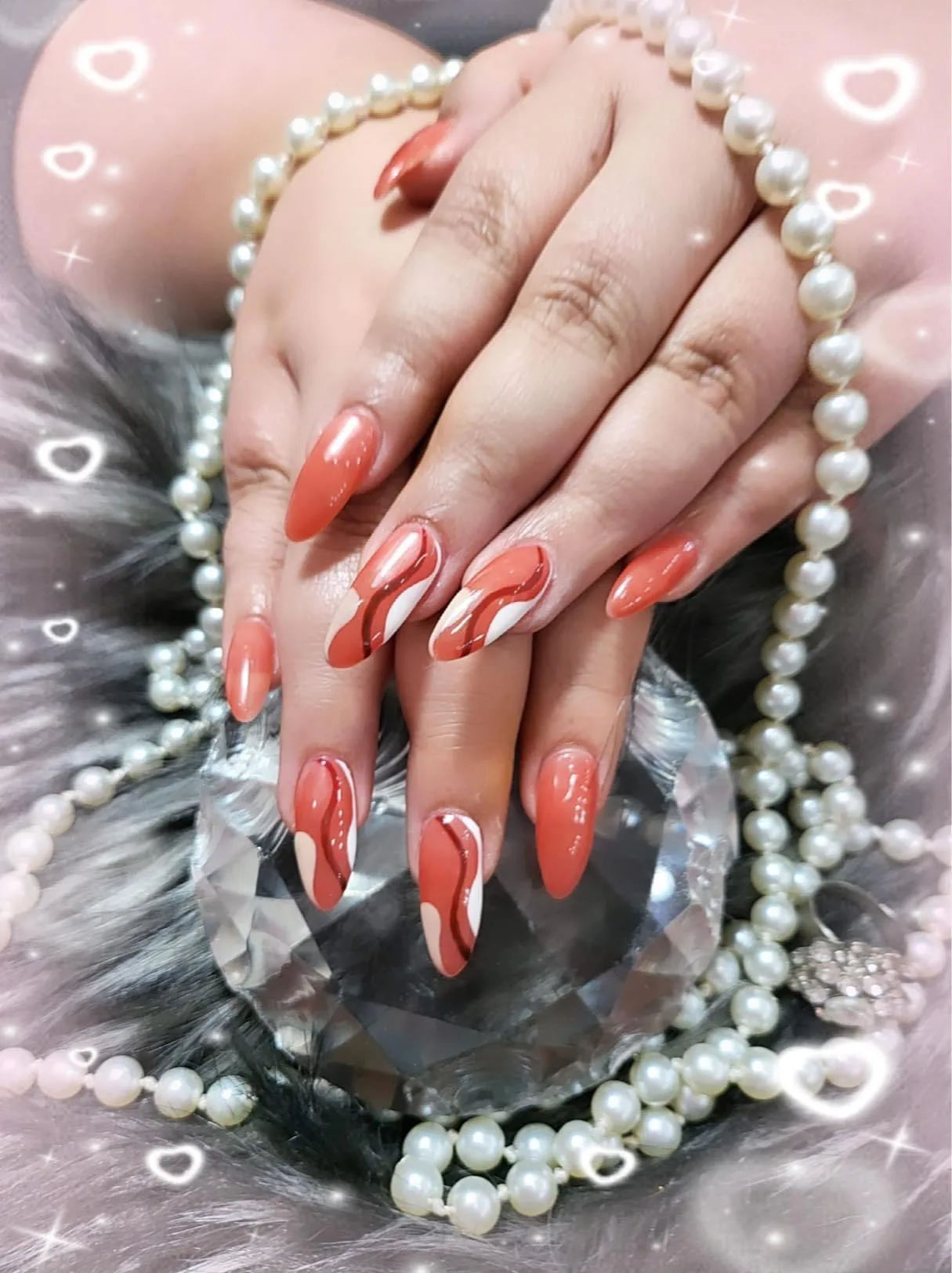 Coral swirl almond nails on crystal with pearls